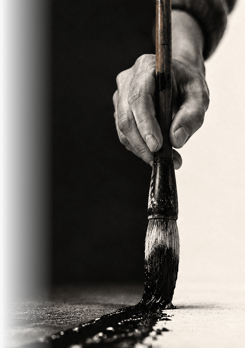 A hand holding a calligraphy brush, painting a stroke of ink